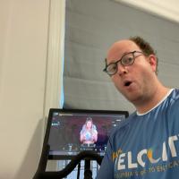 Dr. Aaron Viny on a stationary bike wearing a Velocity t-shirt